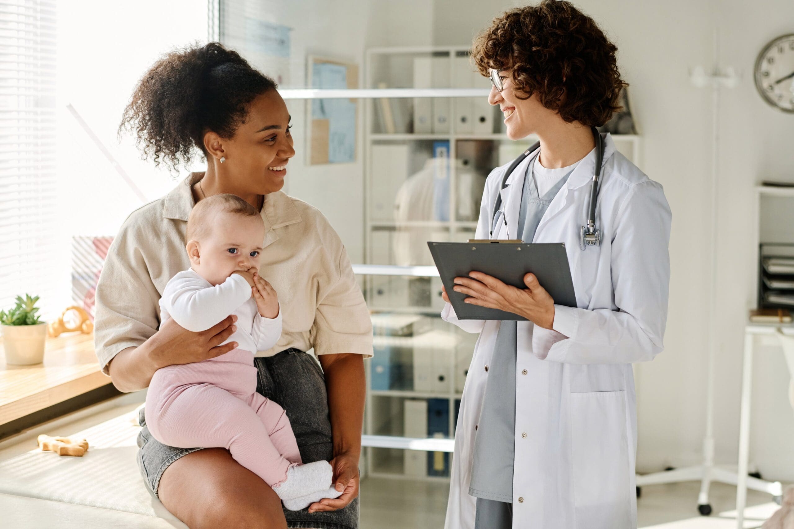 Mother with baby consulting a doctor.